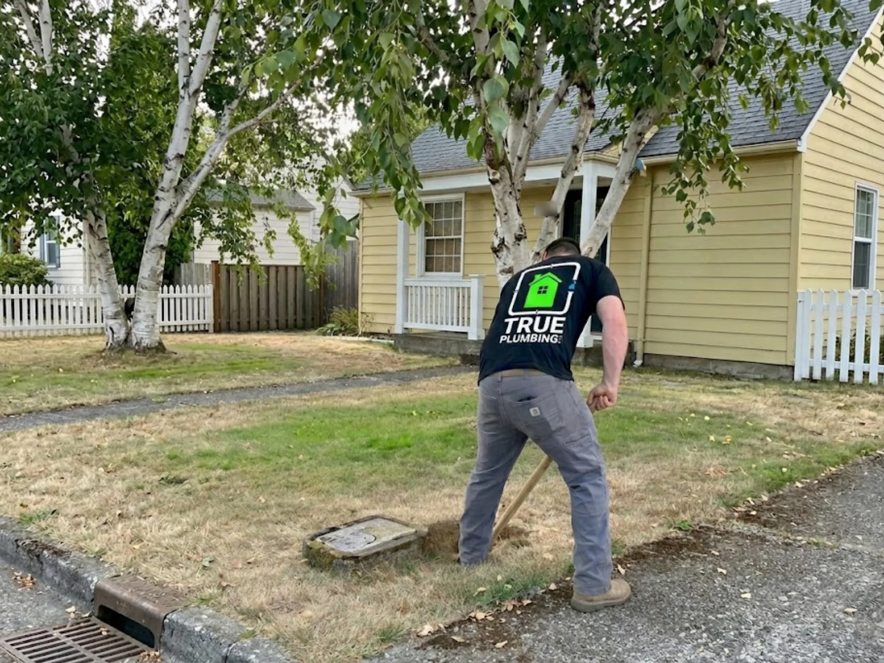 True Plumbing technician excavating near a residential water meter in Clark County