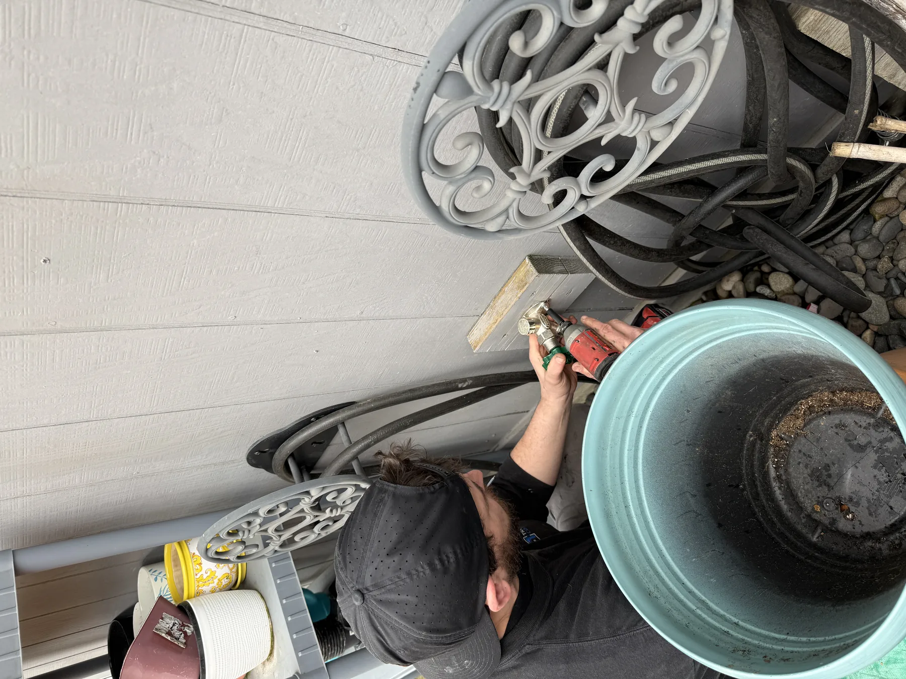 True Plumbing technician repairing an outdoor hose bib connection