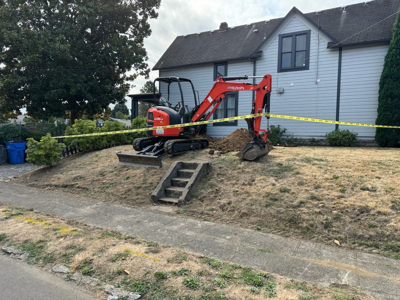 Mini excavator staged at a rural north county home