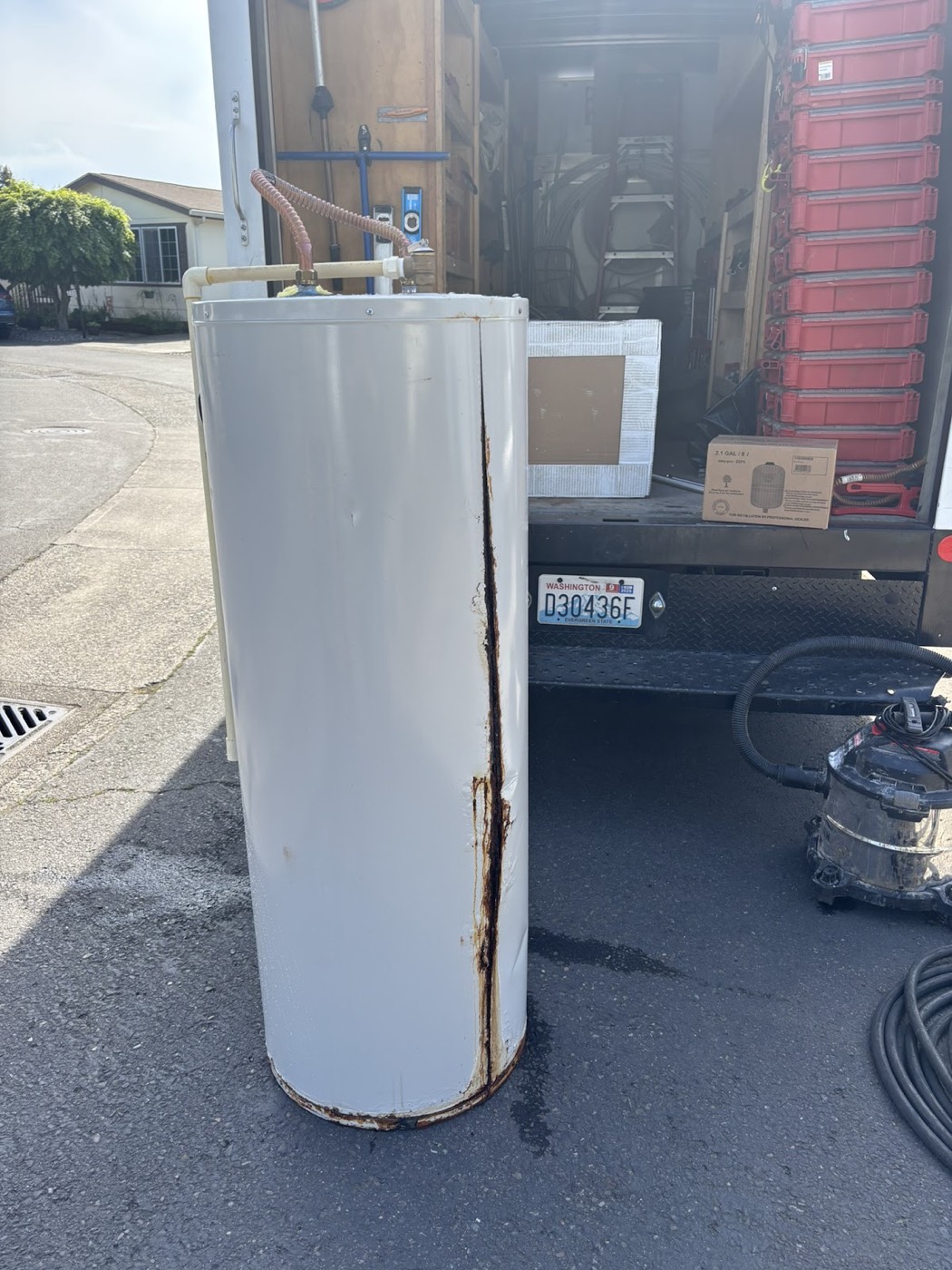 A failed tank water heater, split down the seam, loaded out to the True Plumbing truck